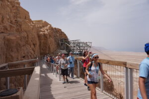 Exiting the tram with other tourists and Israeli students. Visitors can also hike up the mountainside though, in the summer, the temps may hit 114 in the shade.